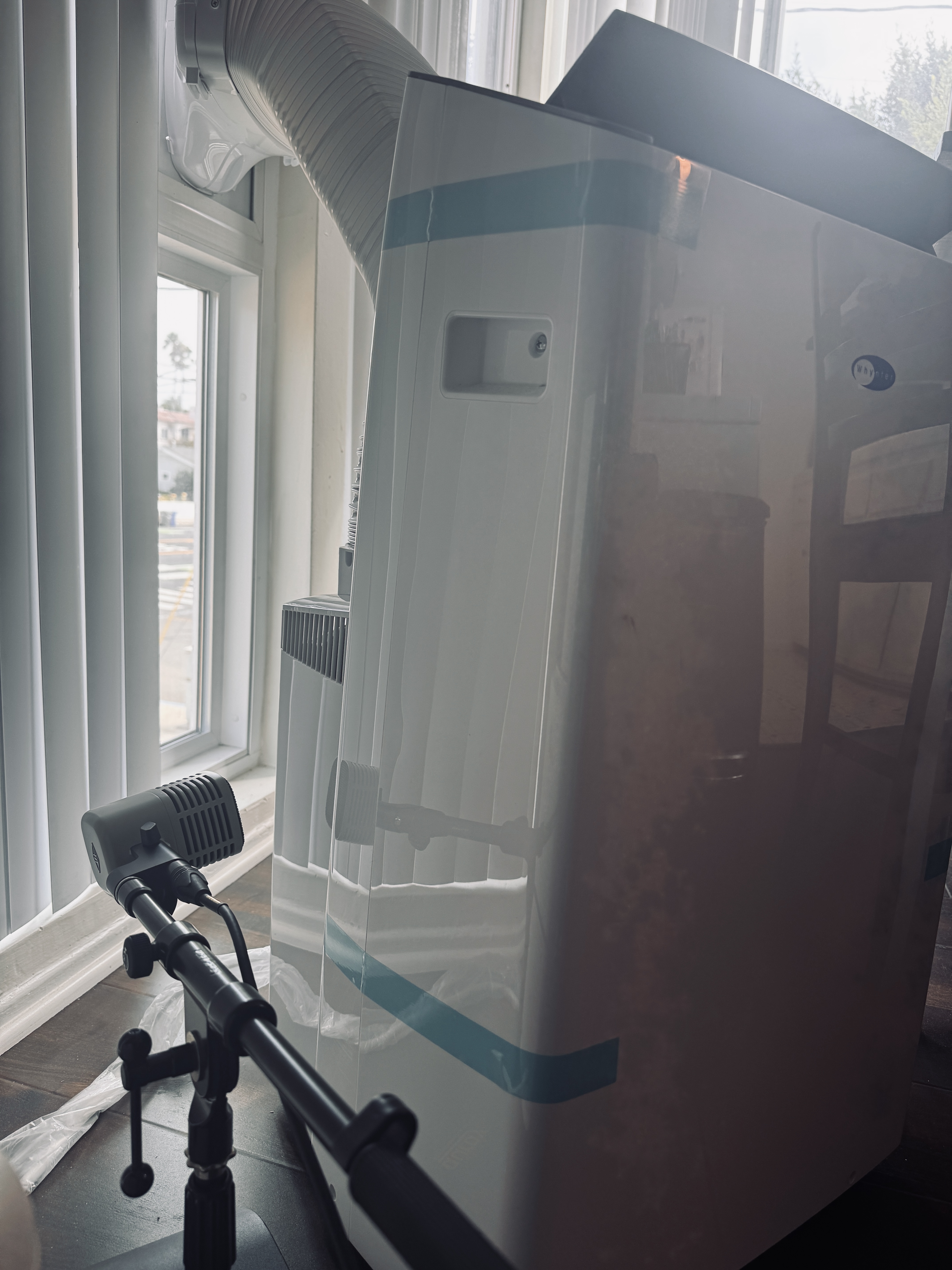 Kick drum microphone placed low against the air conditioner housing